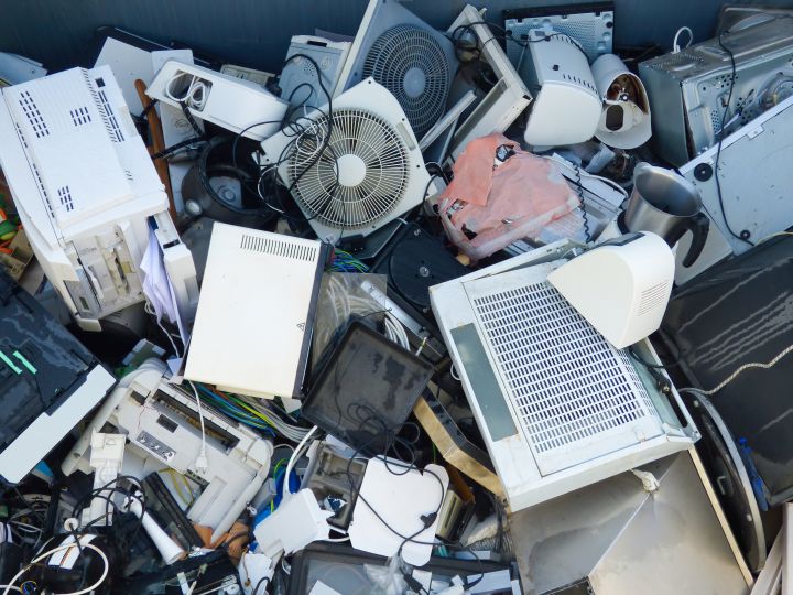 pile of thrown electronics in Singapore from IT equipment printers to fans and appliances